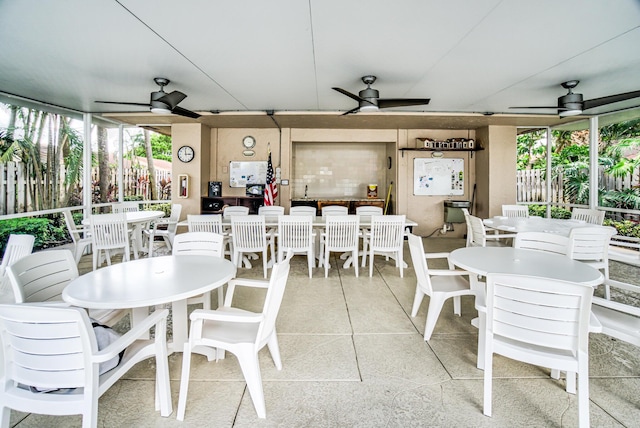 interior space featuring ceiling fan, outdoor dining area, and fence