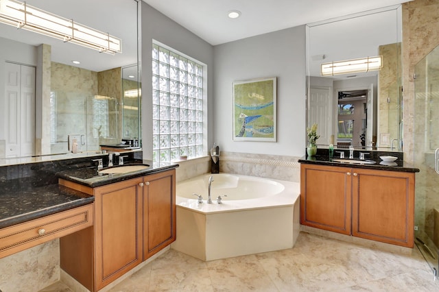 bathroom featuring a healthy amount of sunlight, a sink, and a shower stall