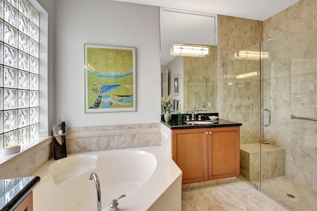 bathroom featuring vanity, a shower stall, and a bath