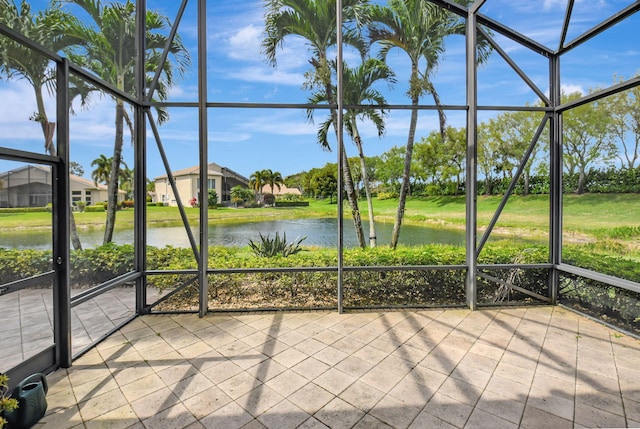 unfurnished sunroom featuring a water view