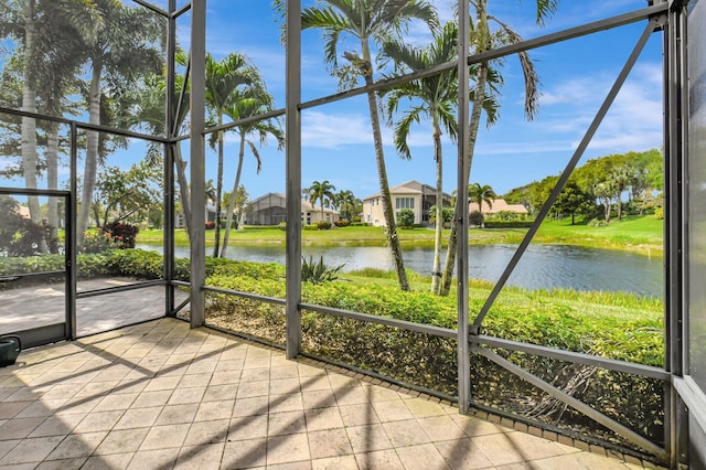 unfurnished sunroom featuring a water view