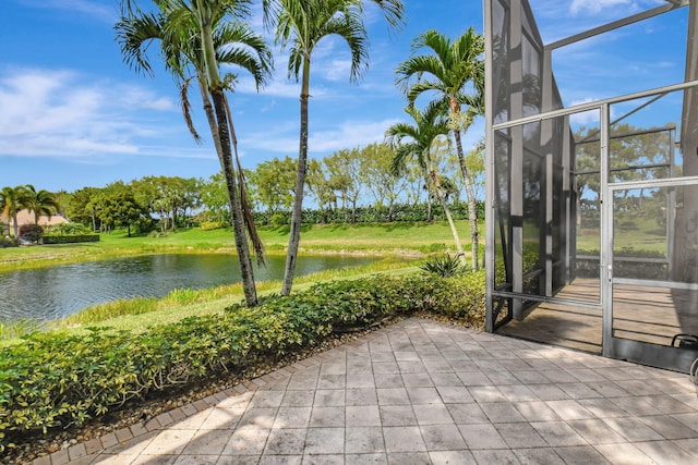 unfurnished sunroom featuring a water view