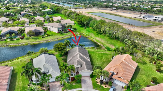 bird's eye view featuring a residential view and a water view