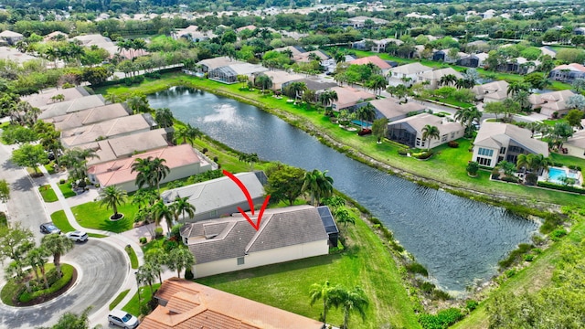 birds eye view of property with a water view and a residential view