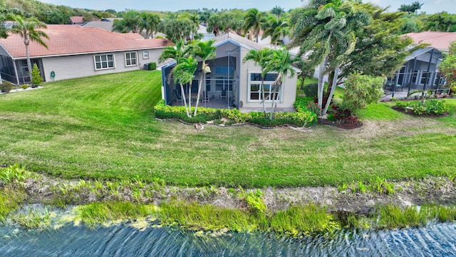 exterior space with a water view and a sunroom