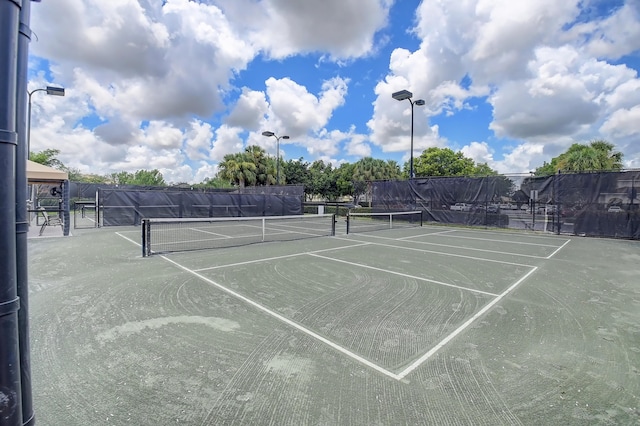 view of sport court featuring fence