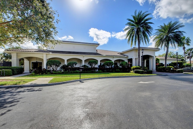 view of building exterior with curved driveway