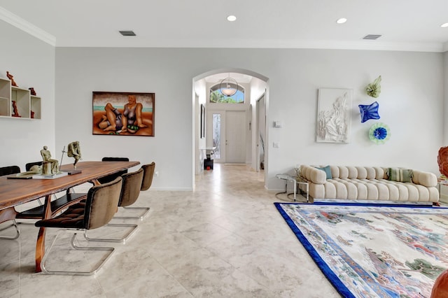 interior space with ornamental molding, arched walkways, visible vents, and baseboards