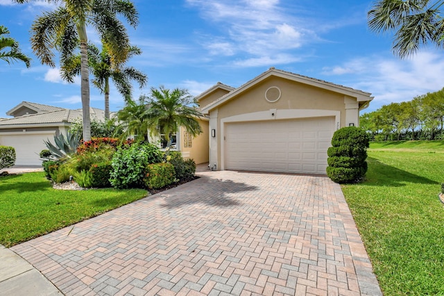 view of front of house featuring a garage, a front yard, decorative driveway, and stucco siding