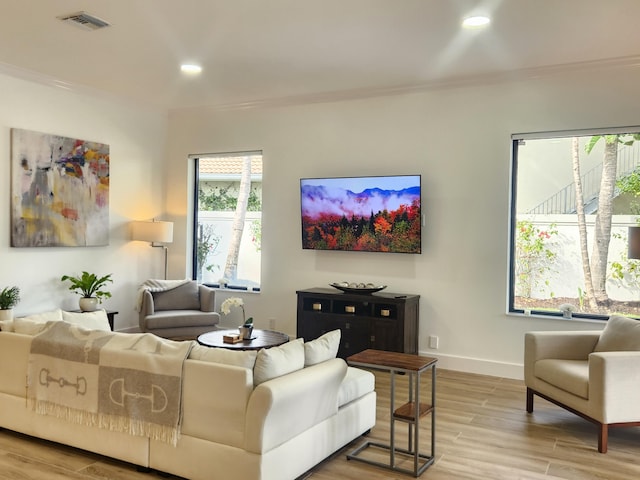 living room with light wood-type flooring, baseboards, visible vents, and recessed lighting