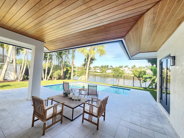 view of patio featuring a fenced in pool, fence private yard, french doors, and a water view