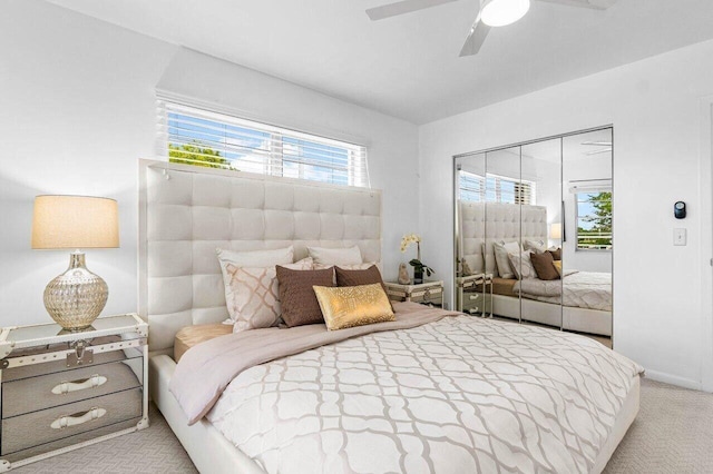 bedroom with carpet floors, a closet, and a ceiling fan