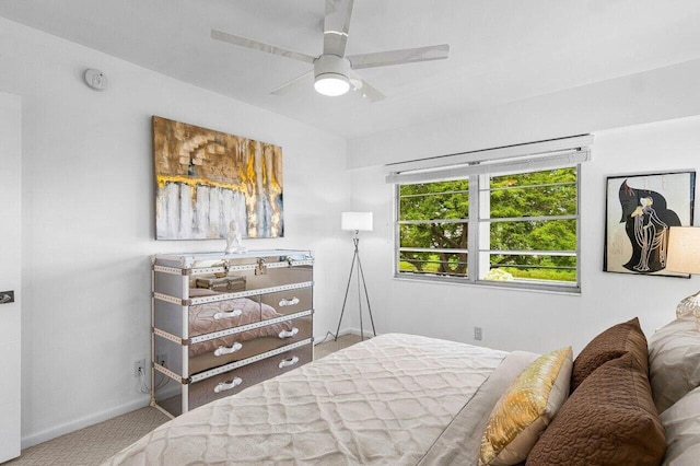 carpeted bedroom with baseboards and a ceiling fan