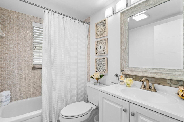 bathroom featuring vanity, toilet, and shower / bathtub combination with curtain