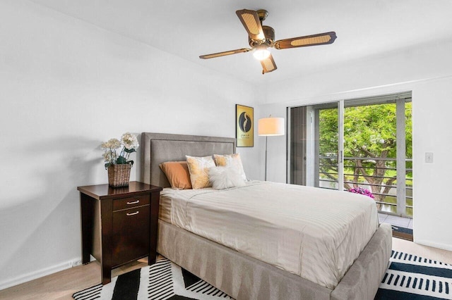 bedroom featuring access to outside, wood finished floors, a ceiling fan, and baseboards