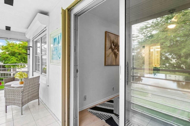 doorway with tile patterned flooring