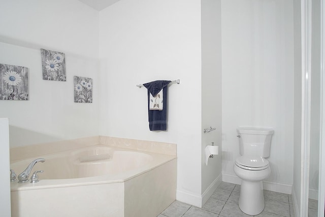 full bath featuring a bath, baseboards, toilet, and tile patterned floors