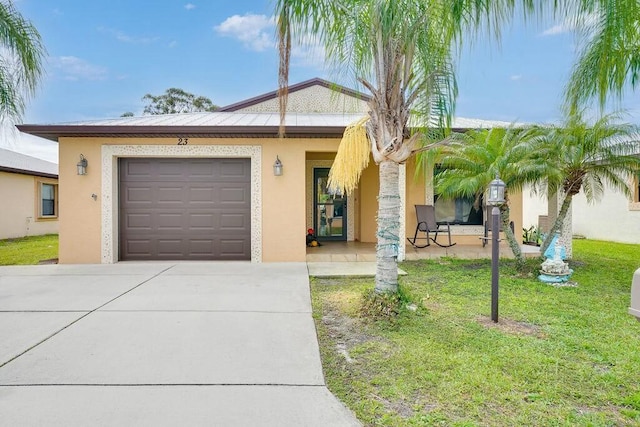 ranch-style home with a garage, concrete driveway, a front lawn, and stucco siding