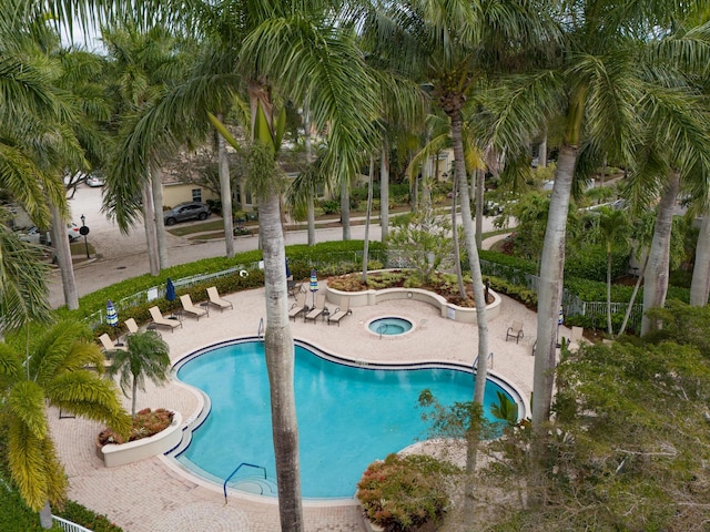 pool featuring a patio and a hot tub