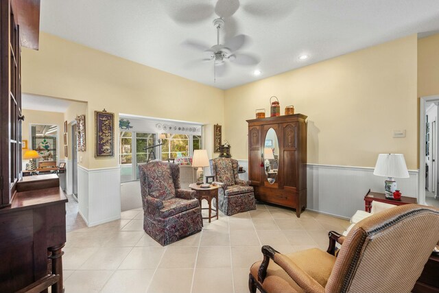 living area with a wainscoted wall, light tile patterned floors, a ceiling fan, and recessed lighting