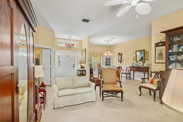 living area featuring light tile patterned floors, ceiling fan, visible vents, and recessed lighting