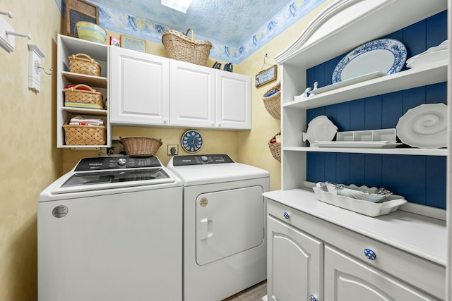 washroom with washer and clothes dryer and cabinet space