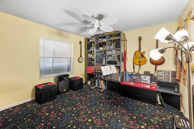 interior space with carpet, a ceiling fan, and baseboards