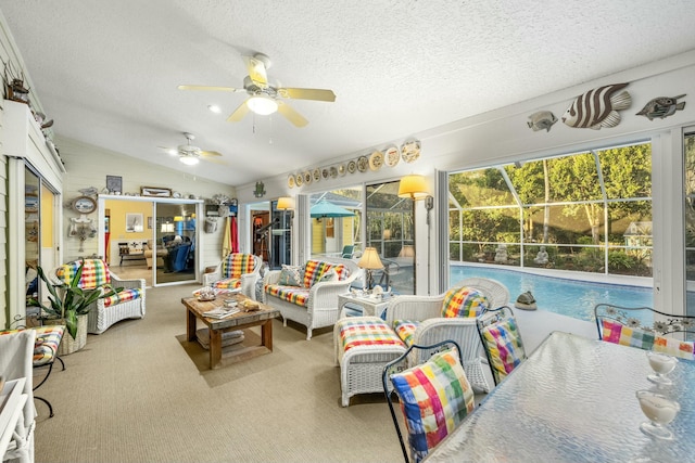 sunroom / solarium featuring lofted ceiling and ceiling fan