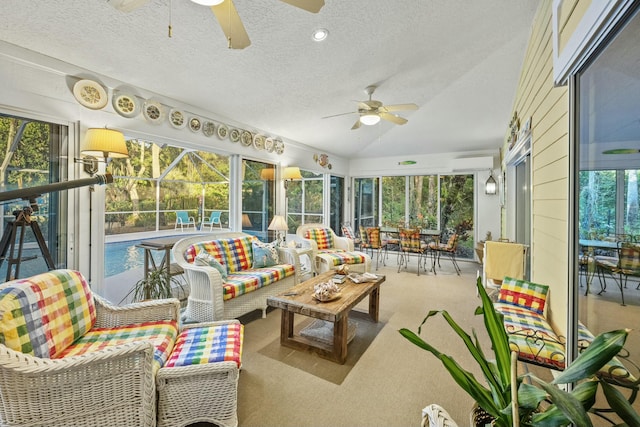 sunroom / solarium featuring vaulted ceiling, a ceiling fan, and an AC wall unit