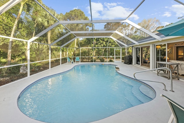 outdoor pool featuring area for grilling and a patio area