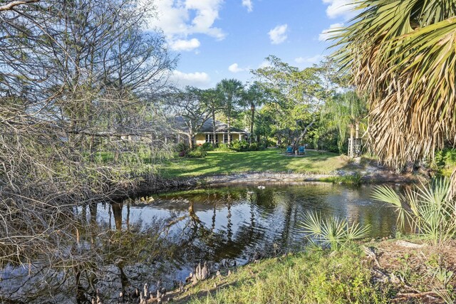 back of property with a patio, a lanai, and an outdoor pool