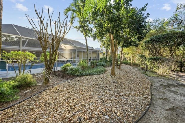 view of yard featuring a lanai and an outdoor pool