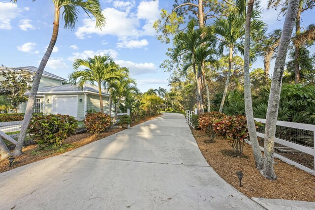 view of street with driveway and a gated entry