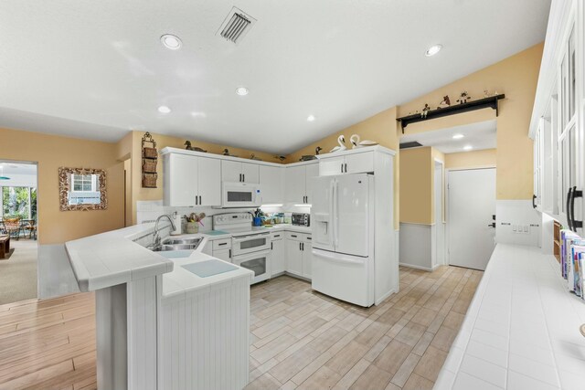 bar with light wood finished floors, tasteful backsplash, and visible vents