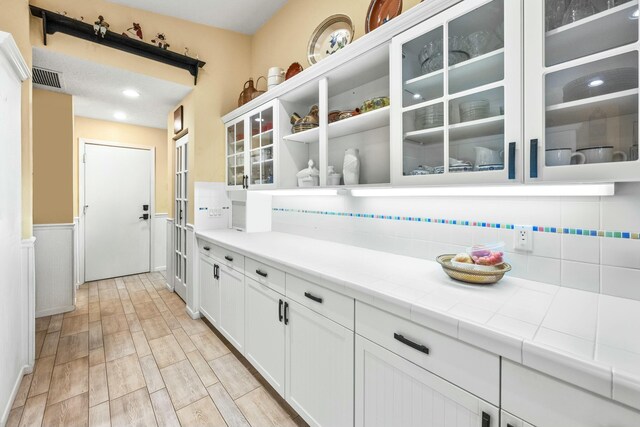 dining space featuring wainscoting, visible vents, french doors, and an inviting chandelier