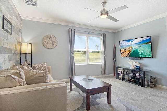 living room featuring visible vents, baseboards, ceiling fan, ornamental molding, and a textured ceiling