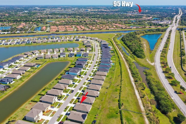 bird's eye view featuring a residential view and a water view