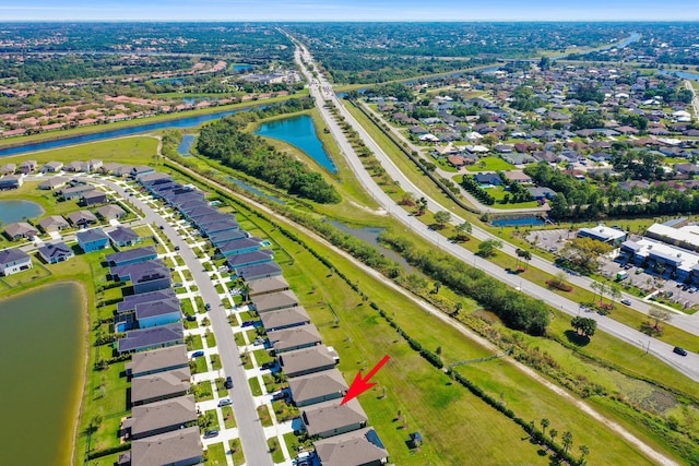 drone / aerial view featuring a residential view and a water view