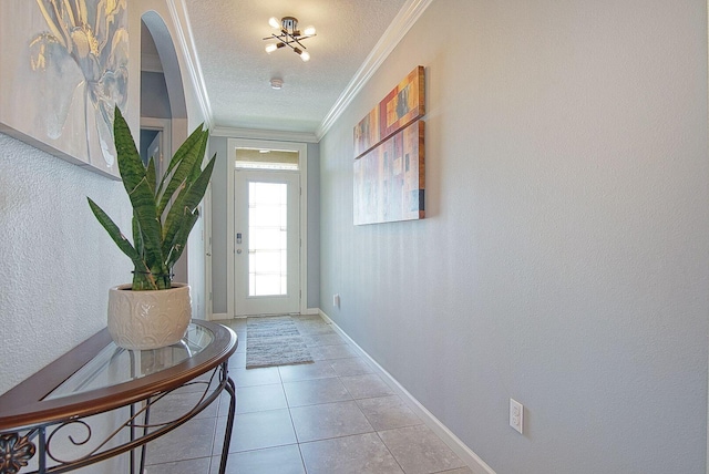 doorway with tile patterned flooring, a textured ceiling, baseboards, and crown molding