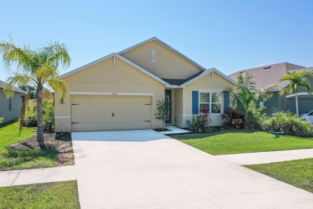 view of front of home with a garage, driveway, a front lawn, and stucco siding