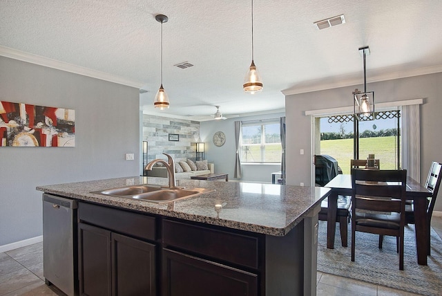 kitchen featuring a sink, a textured ceiling, visible vents, and stainless steel dishwasher