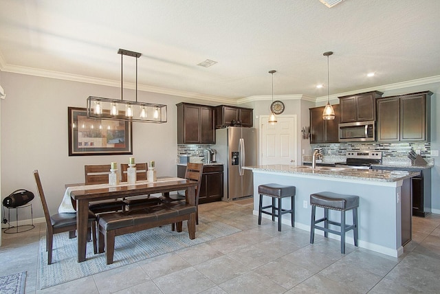 dining space featuring light tile patterned floors, baseboards, visible vents, and ornamental molding