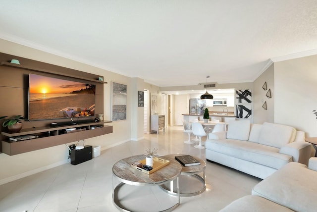 tiled living room with visible vents, crown molding, and baseboards