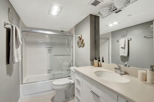 bathroom with visible vents, toilet, enclosed tub / shower combo, tile patterned flooring, and vanity