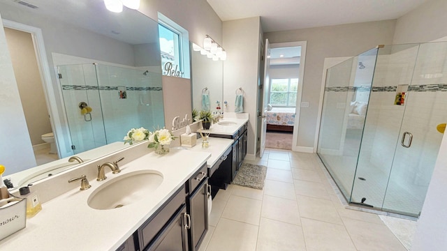 9592 SW Royal Poinciana Dr, Port Saint Lucie, FL 34987 - ensuite bathroom featuring tile patterned floors, a sink, a shower stall, and double vanity