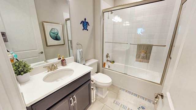 9592 SW Royal Poinciana Dr, Port Saint Lucie, FL 34987 - full bathroom featuring vanity, bath / shower combo with glass door, tile patterned flooring, and toilet