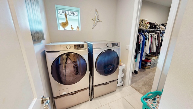 9592 SW Royal Poinciana Dr, Port Saint Lucie, FL 34987 - laundry area featuring laundry area, washing machine and dryer, carpet, and tile patterned flooring