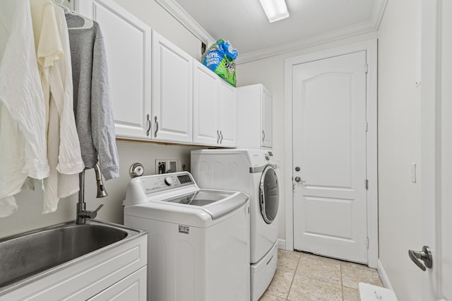 laundry area featuring baseboards, cabinet space, crown molding, and washing machine and clothes dryer