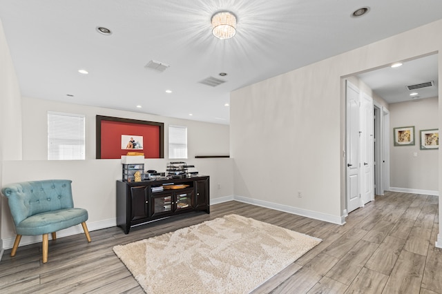 bar with baseboards, visible vents, and wood finished floors