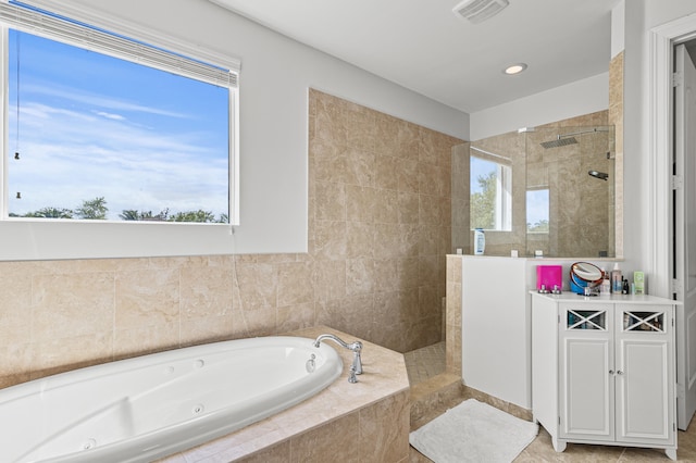 full bath featuring tile patterned flooring, visible vents, a tub with jets, and a walk in shower